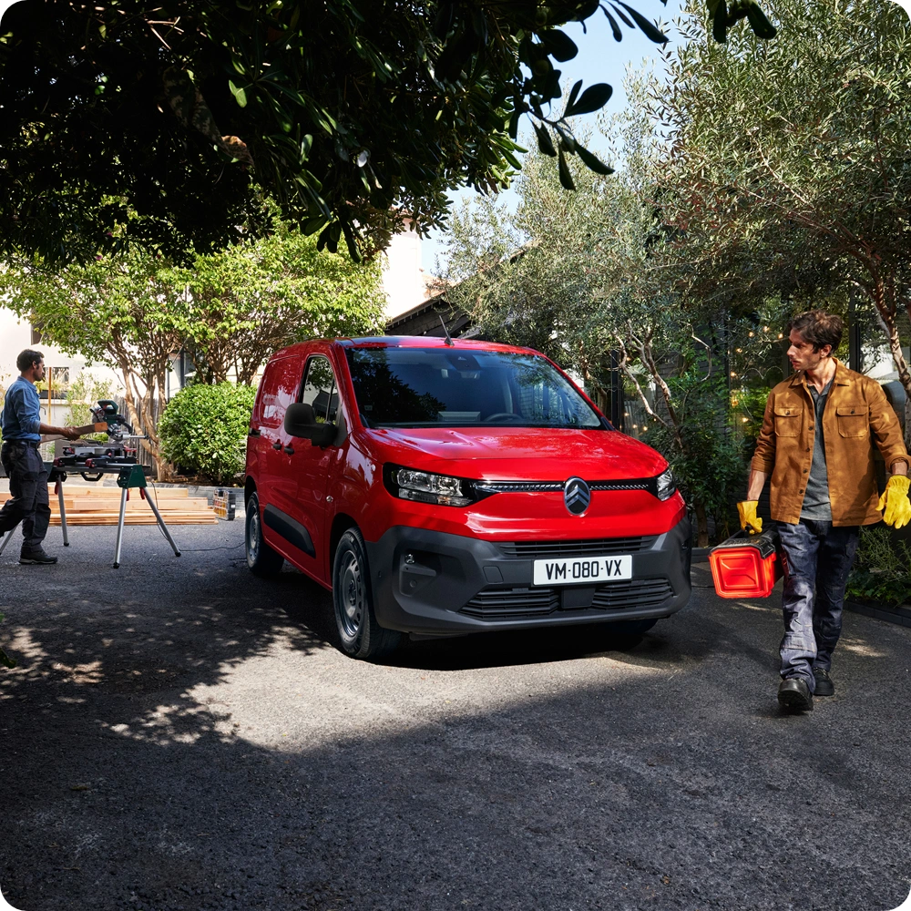 Three‑quarter front view of a Citroën Berlingo Van in a work environment, showing versatility, practicality and business‑ready design.