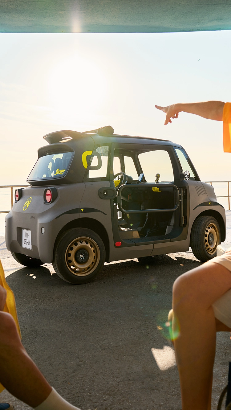 Side beach view Citroën Ami shows compact safe reliable electric design offering innovative summer freedom.