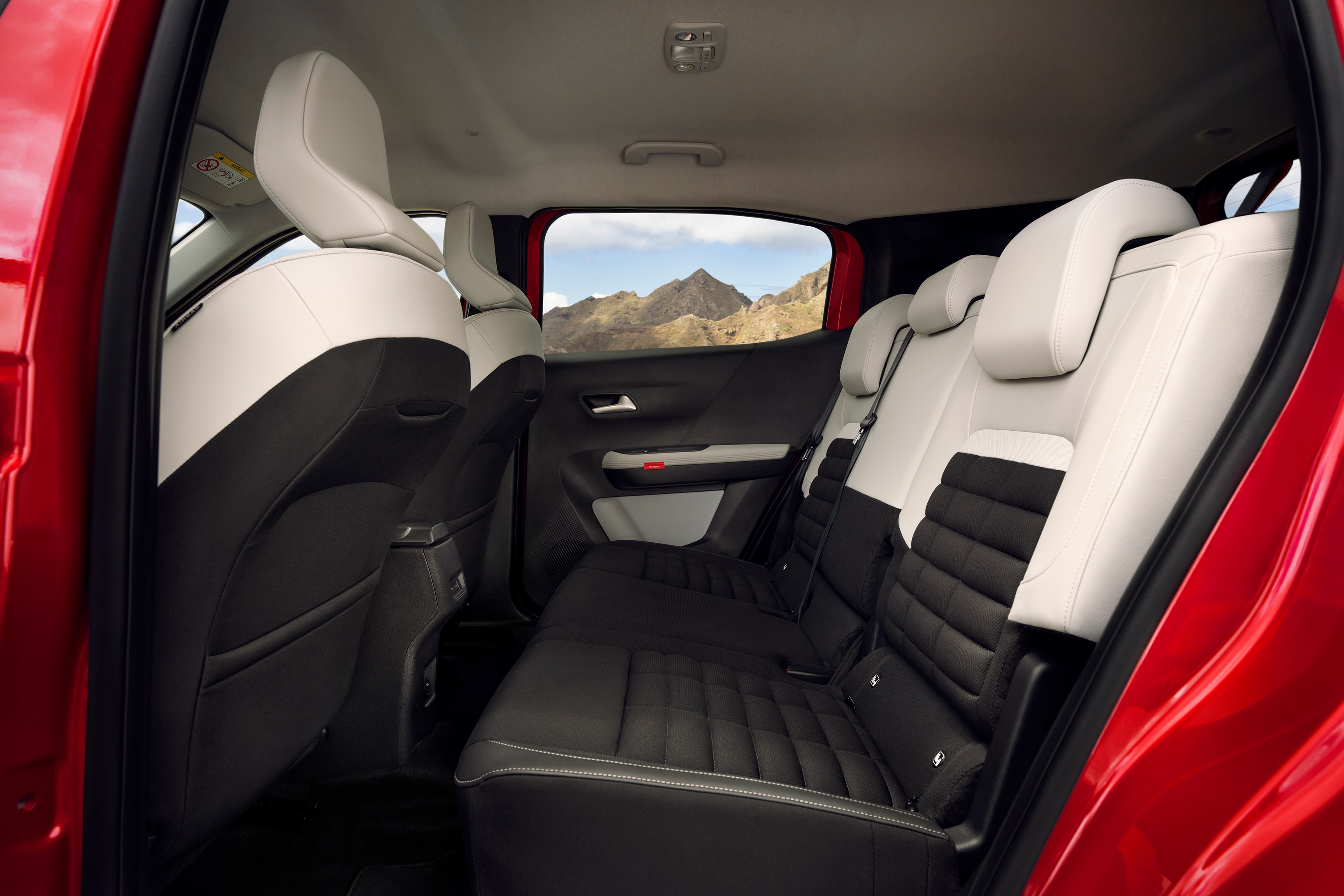 Rücksitze des Citroën Kompakt-SUV gezeigt mit schwarz-weißer Polsterung und Bergblick nach draußen.